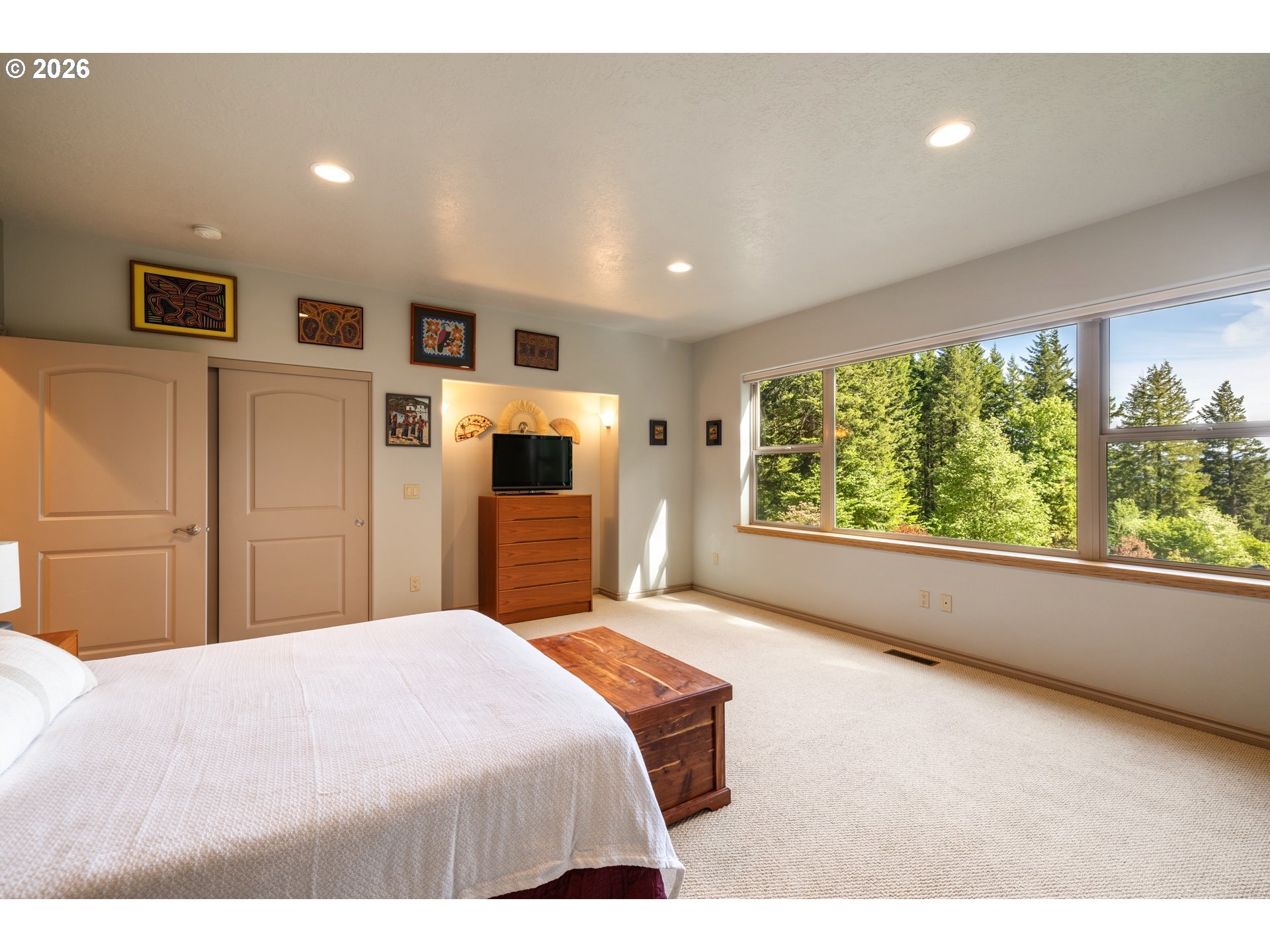 9491 Cook-Underwood Road Underwood, WA 98651 - Photo 23 of 46 a bedroom with a large bed and a large window