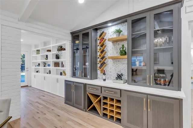 a kitchen with stainless steel appliances a cabinets and wooden floor