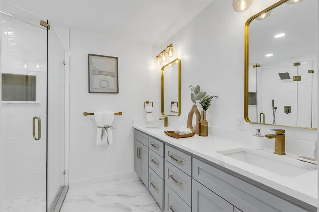 a bathroom with double vanity sink a mirror and shower