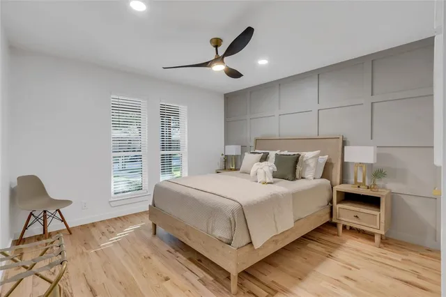 a bed room with a bed and a chair