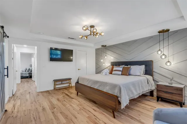 a bedroom with a bed a table and chair