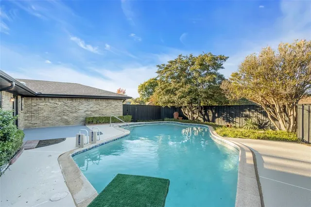a view of a swimming pool with a patio