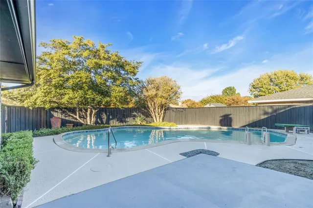 a view of a swimming pool with a patio