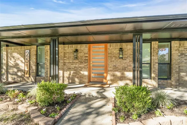 a view of a room that has a large window and deck