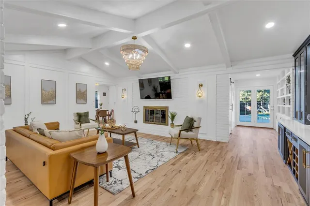 a living room with furniture wooden floor and a flat screen tv