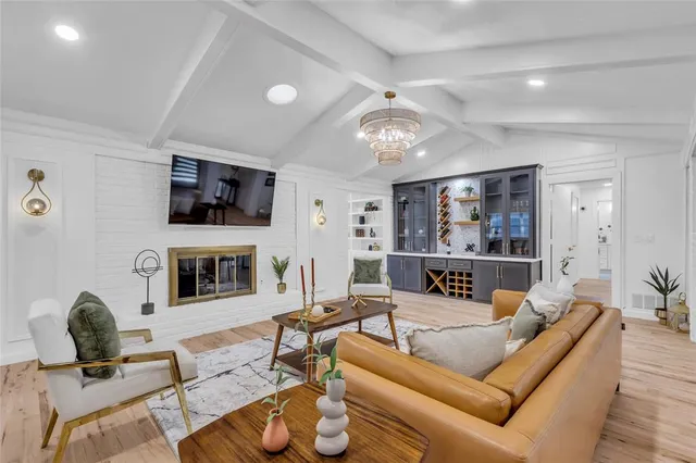a living room with furniture a fireplace and a flat screen tv