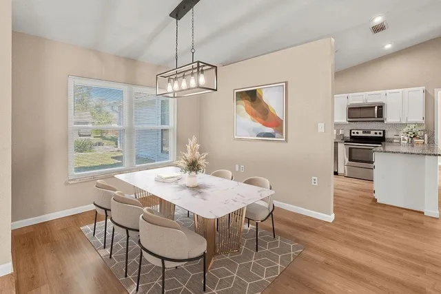 a view of a dining room with furniture window and wooden floor
