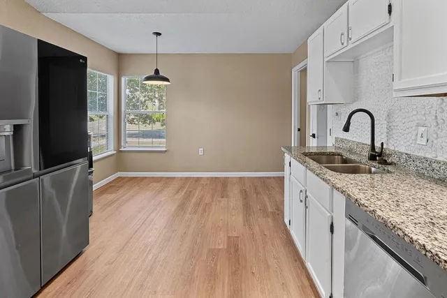 a view of a kitchen with refrigerator and microwave