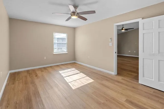 wooden floor in an empty room with a window