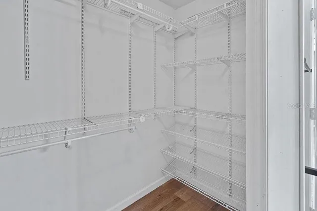 a view of a room with wooden floor