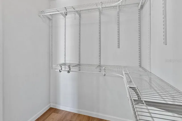 a view of a kitchen with a sink and wooden floor