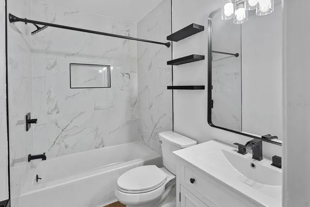 a bathroom with a toilet a sink and shower