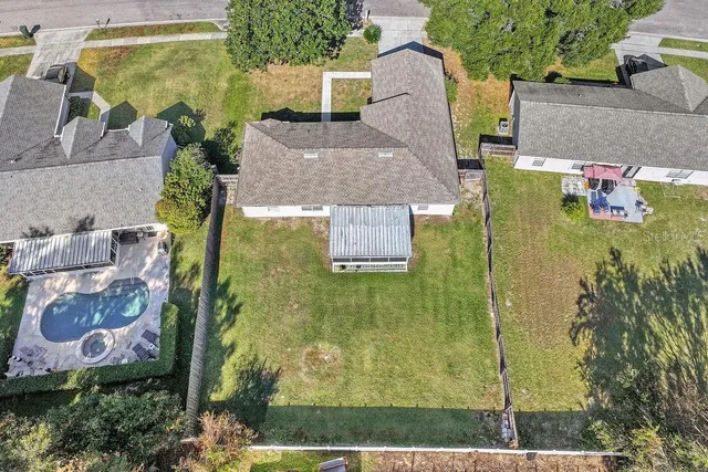 an aerial view of a house with a yard