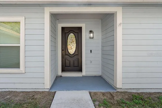 a view of a door of a house with a small yard