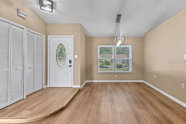 wooden floor in an empty room with a window