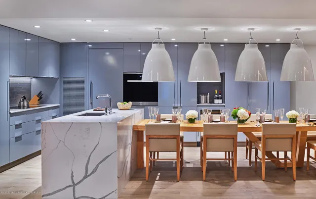 a large kitchen with a table and chairs