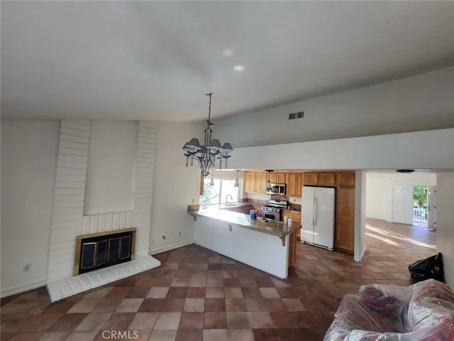 a kitchen with stainless steel appliances granite countertop a stove and a refrigerator