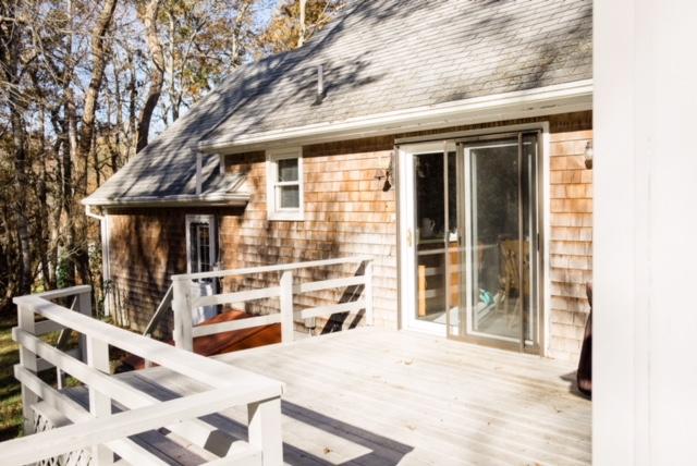 26 Crowell Road Sandwich, MA 02563 - Photo 5 of 14 a view of a house with a large window and wooden fence