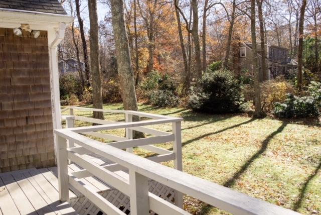 26 Crowell Road Sandwich, MA 02563 - Photo 6 of 14 a view of a balcony with a bench and trees
