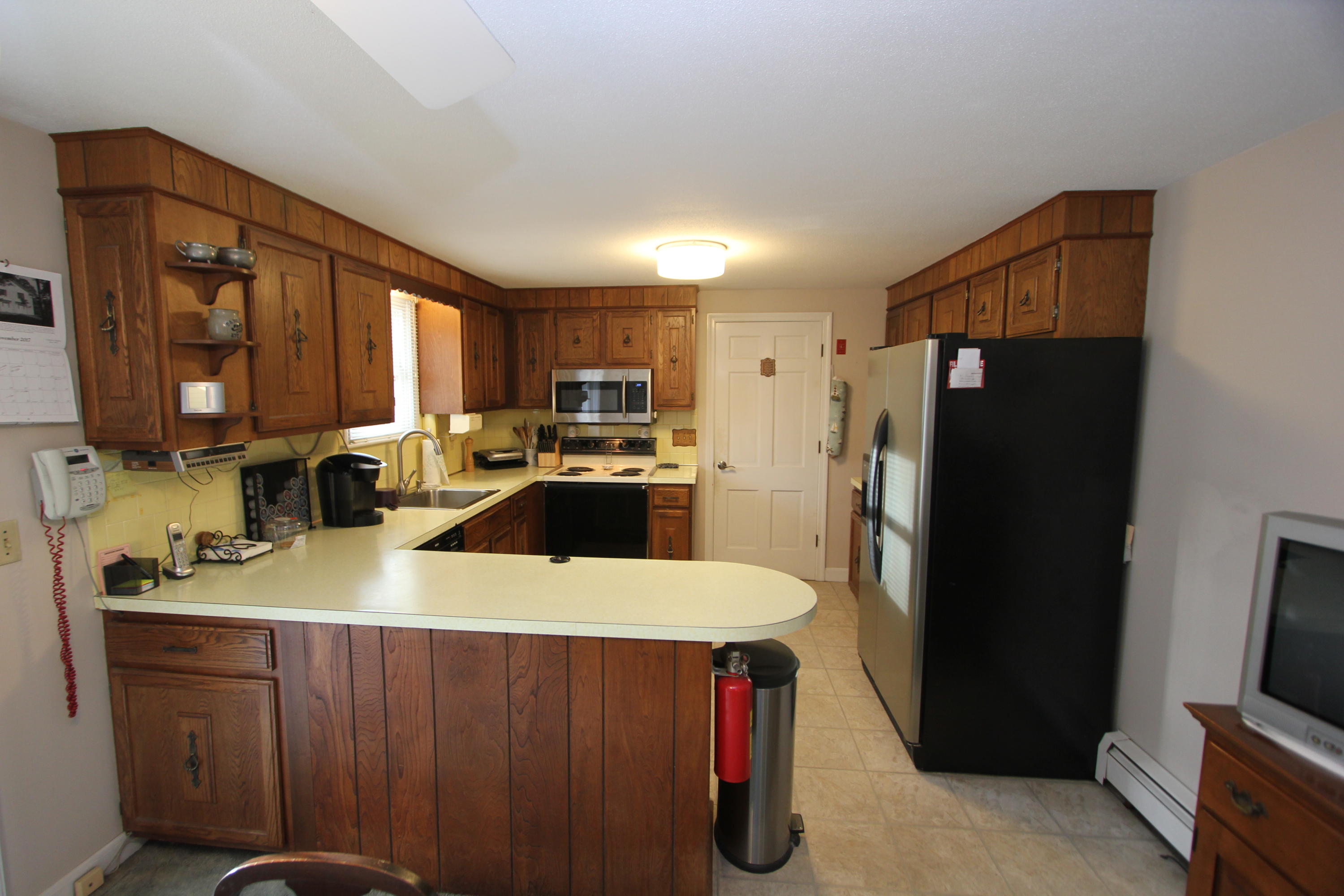 26 Crowell Road Sandwich, MA 02563 - Photo 8 of 14 a kitchen with a refrigerator a stove and a sink