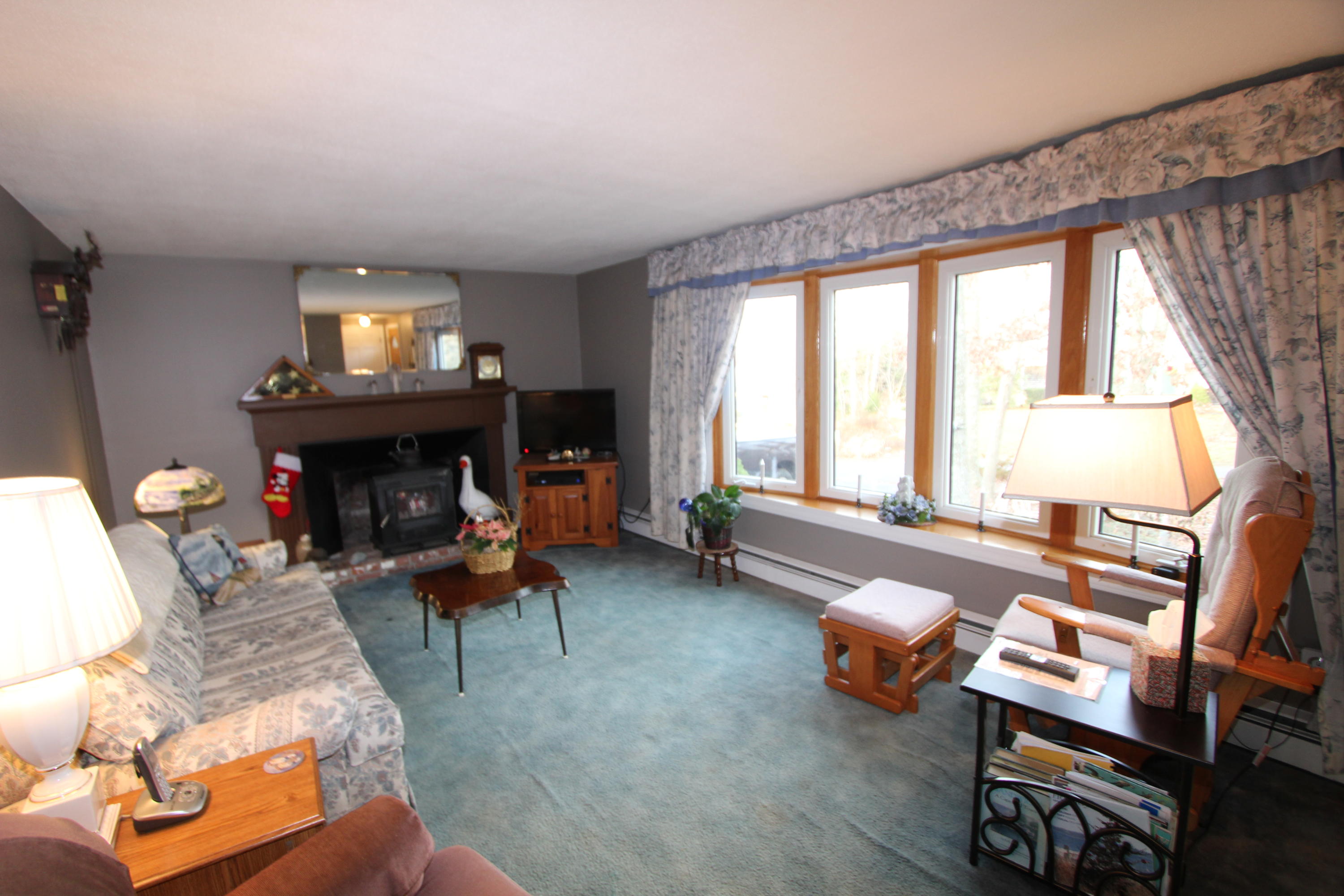 26 Crowell Road Sandwich, MA 02563 - Photo 9 of 14 a living room with furniture and a fireplace