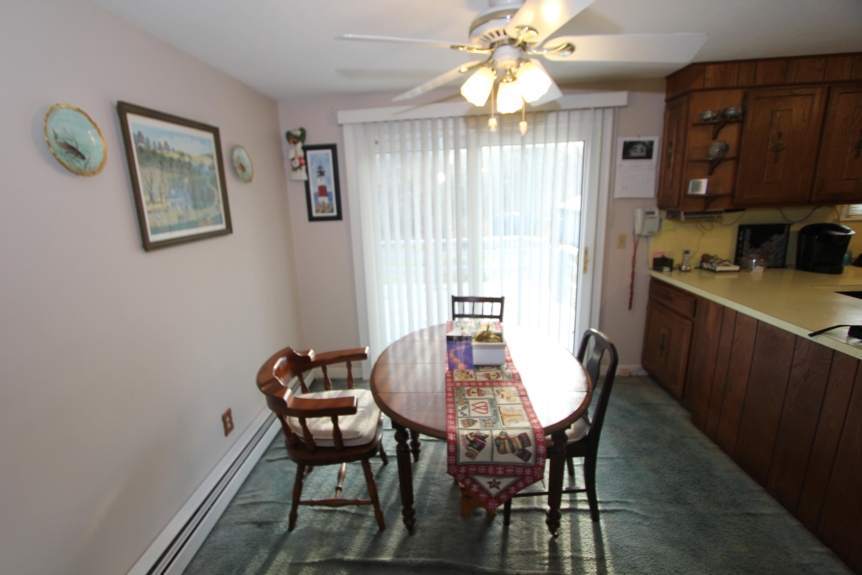26 Crowell Road Sandwich, MA 02563 - Photo 10 of 14 a view of a dining room with furniture window and wooden floor