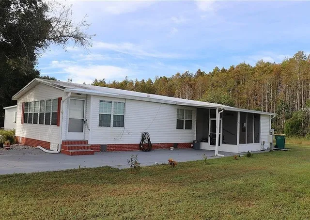 a view of a house with backyard and porch