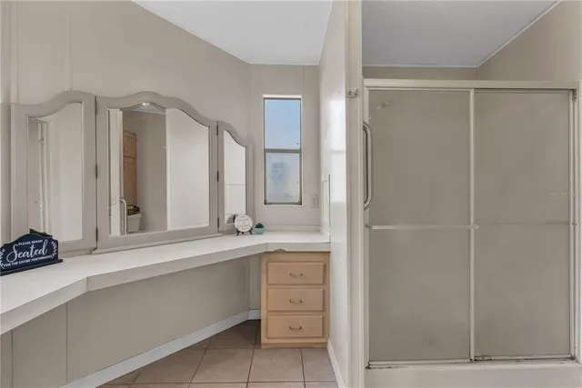 a bathroom with a shower sink and mirror