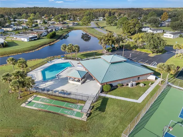an aerial view of a pool a yard ocean and mountain view