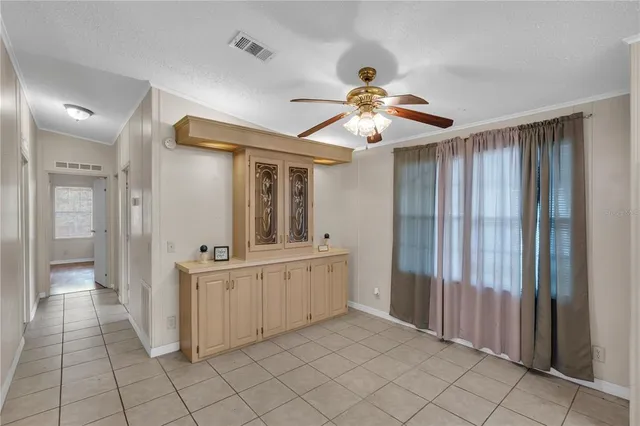 a view of a hallway with chandelier fan