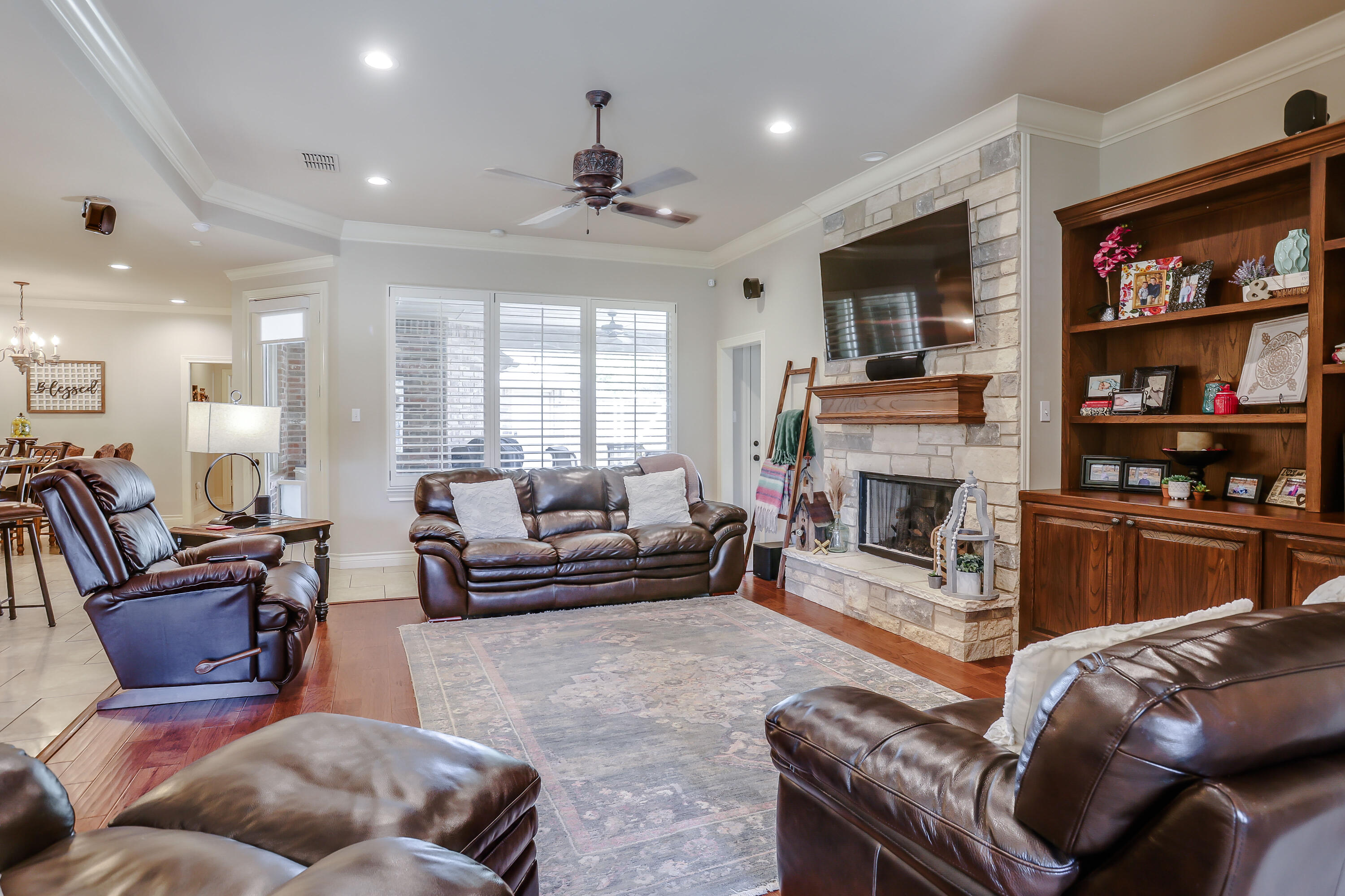 3804 103rd Street Lubbock, TX 79423 - Photo 2 of 32 a living room with furniture a flat screen tv and a fireplace