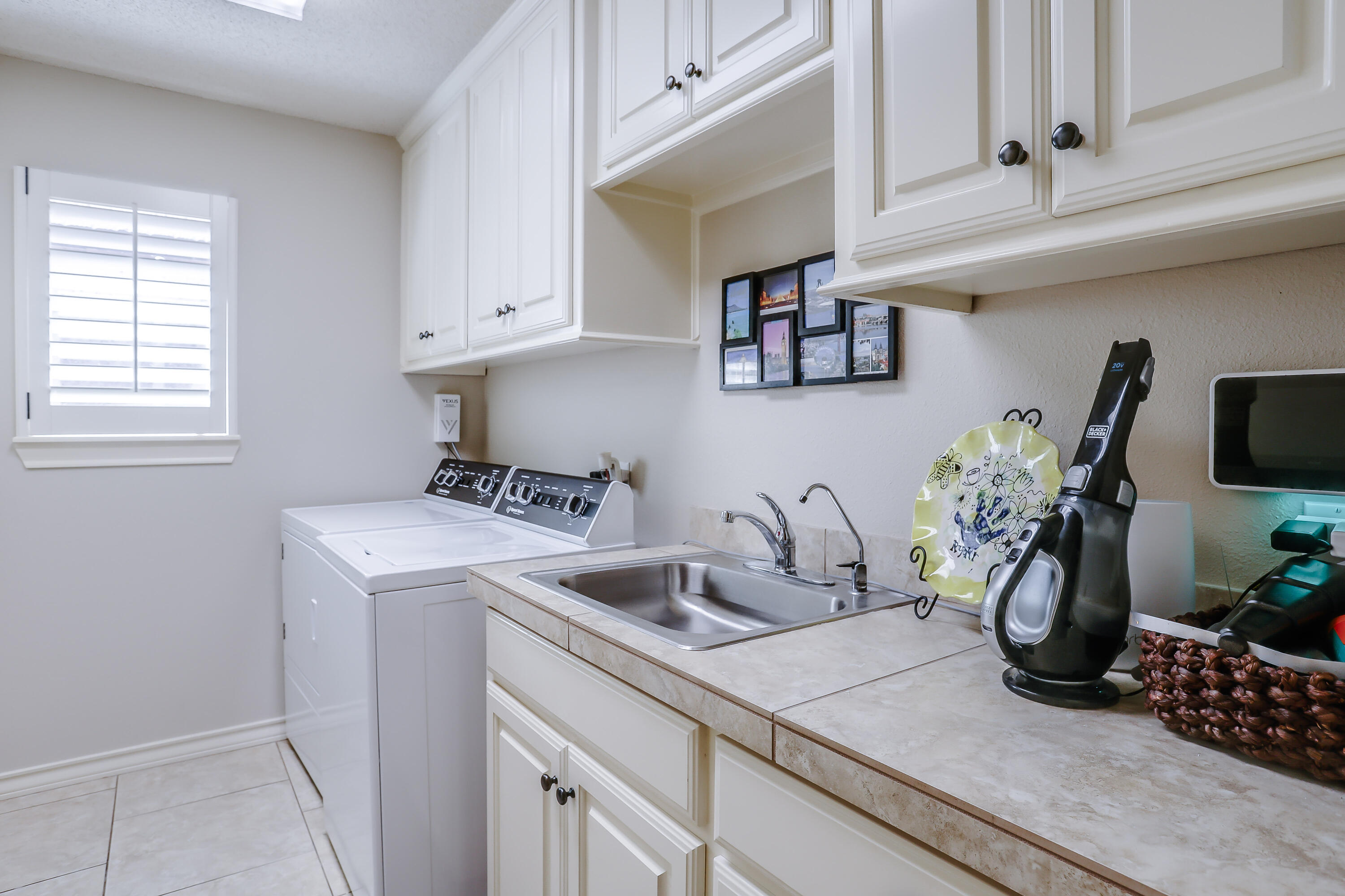 3804 103rd Street Lubbock, TX 79423 - Photo 24 of 32 a kitchen with a sink and cabinets