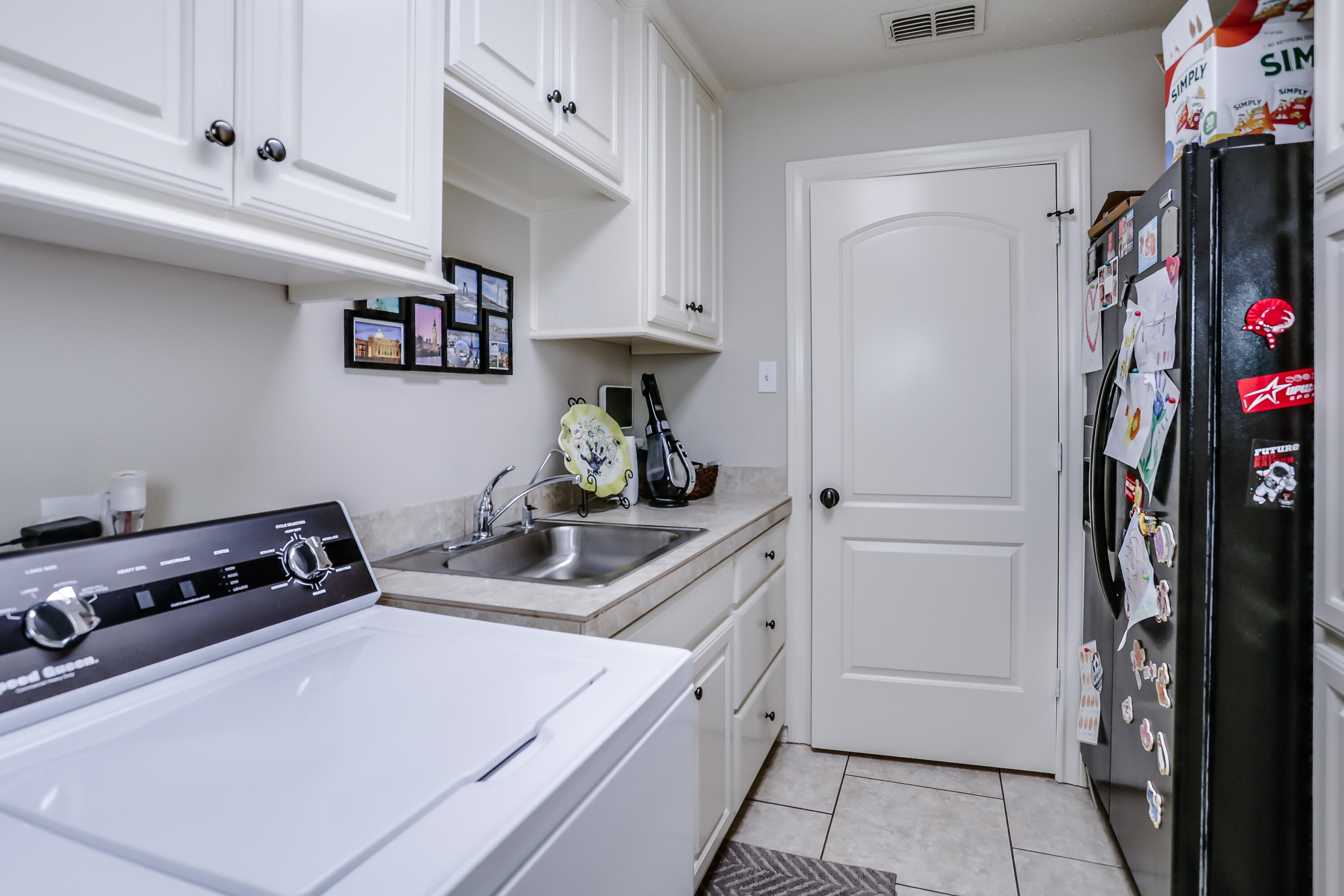 3804 103rd Street Lubbock, TX 79423 - Photo 25 of 32 a kitchen with stainless steel appliances a cabinets and a stove top oven