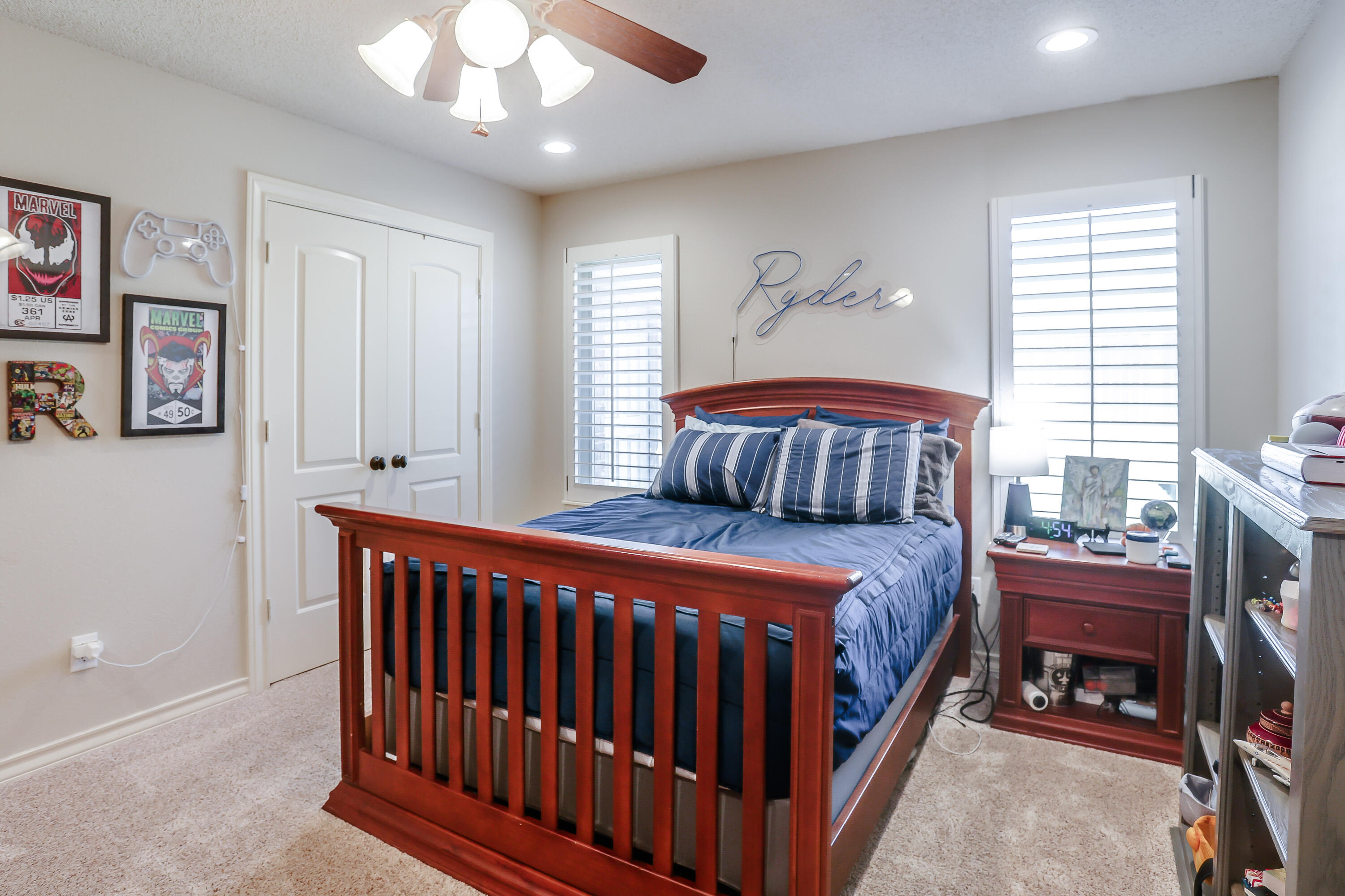 3804 103rd Street Lubbock, TX 79423 - Photo 26 of 32 a bedroom with a bed and a chandelier
