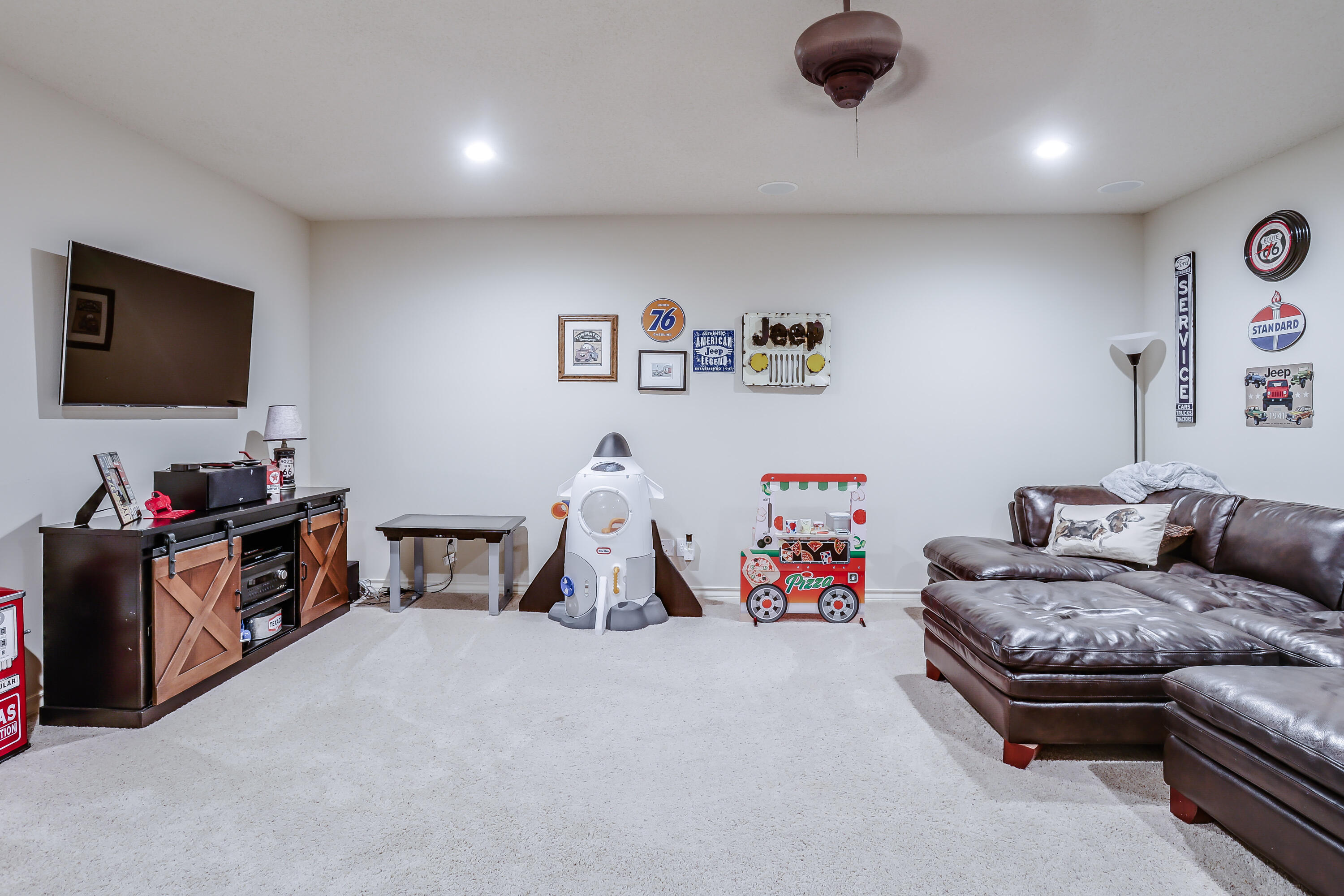 3804 103rd Street Lubbock, TX 79423 - Photo 28 of 32 a living room with furniture and a flat screen tv