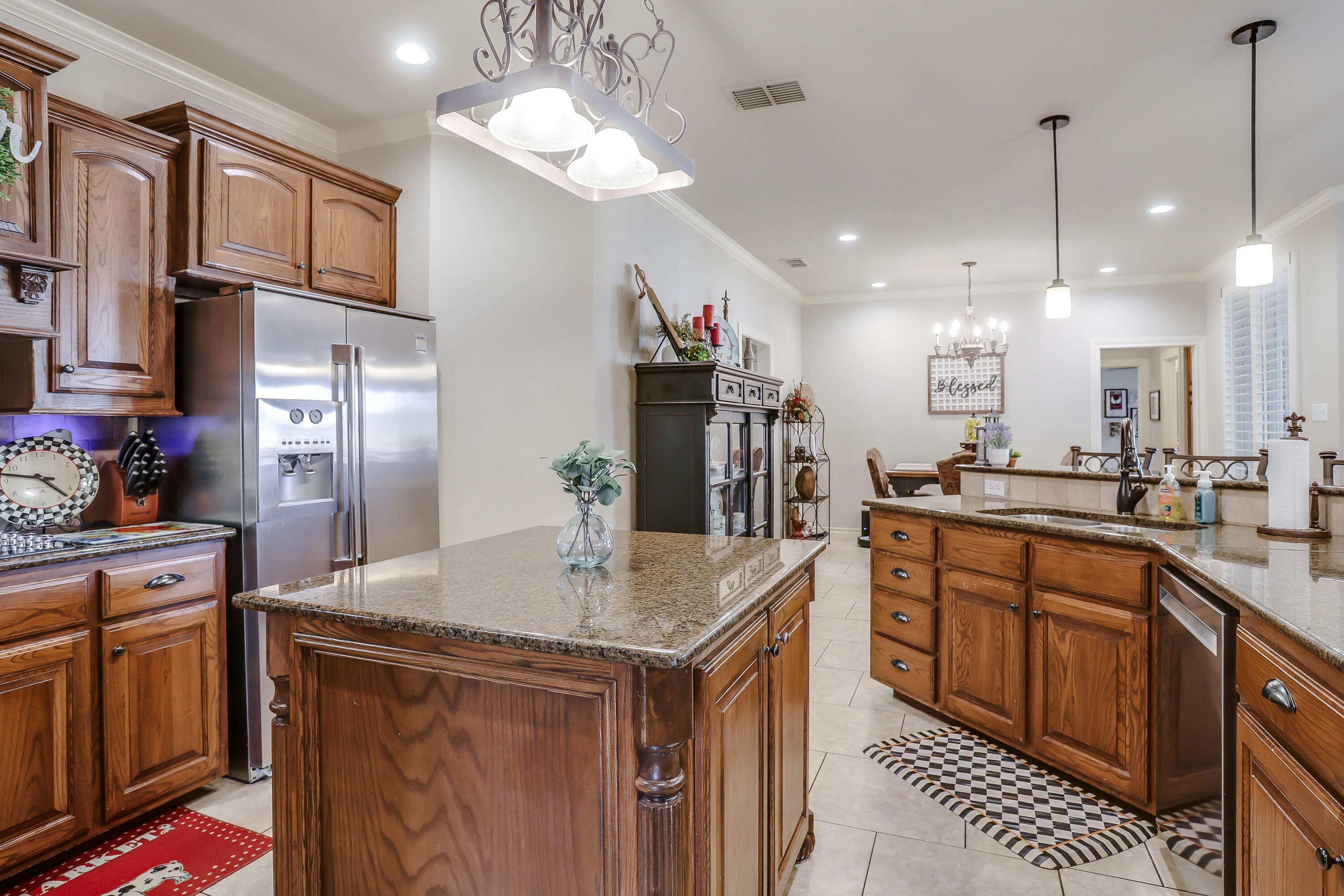 3804 103rd Street Lubbock, TX 79423 - Photo 6 of 32 a kitchen with stainless steel appliances granite countertop a sink a stove and a refrigerator