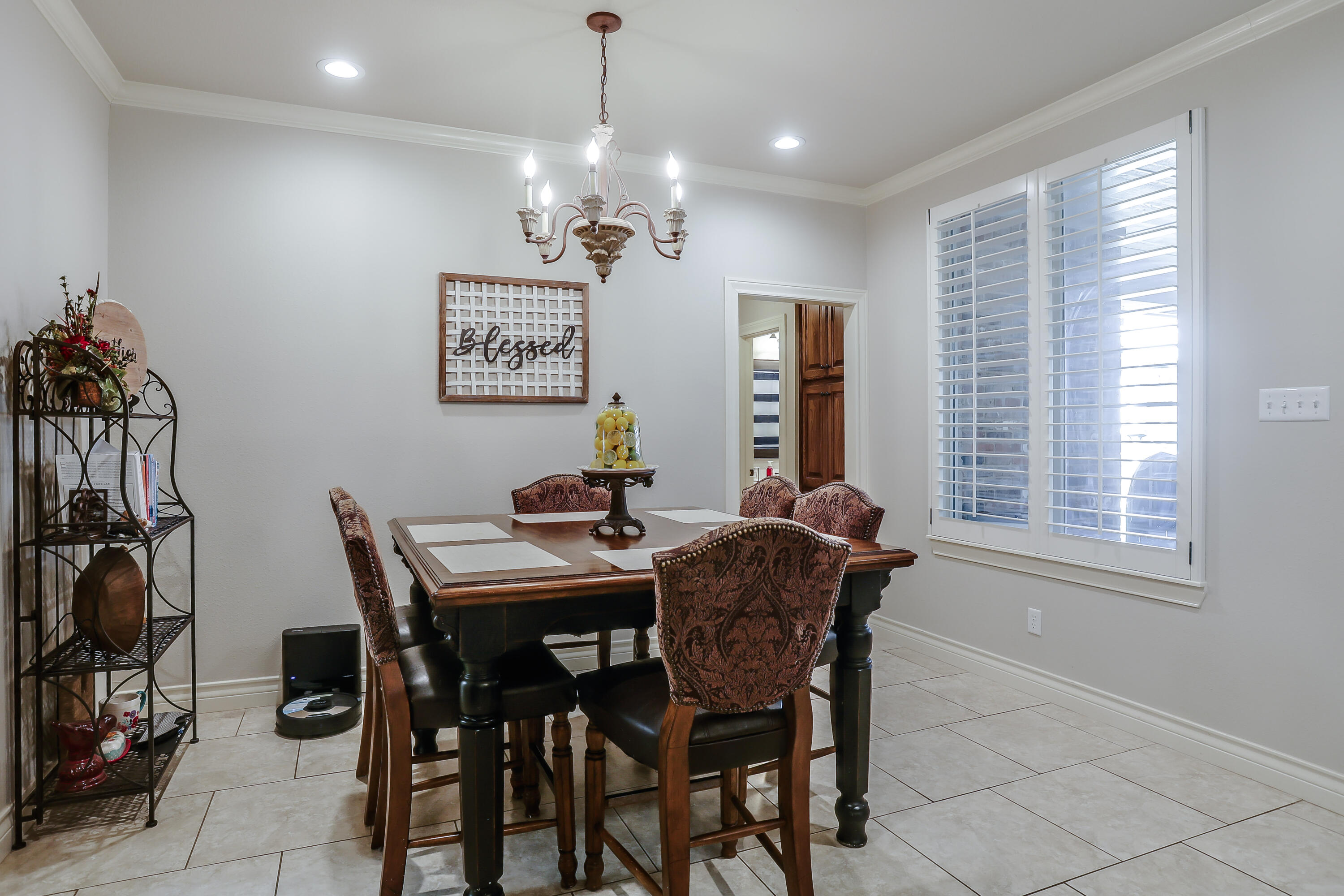 3804 103rd Street Lubbock, TX 79423 - Photo 10 of 32 a view of a dining room with furniture and a chandelier