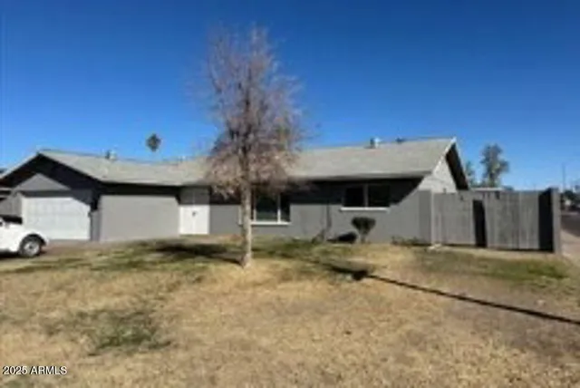a view of a house with a yard and sitting area