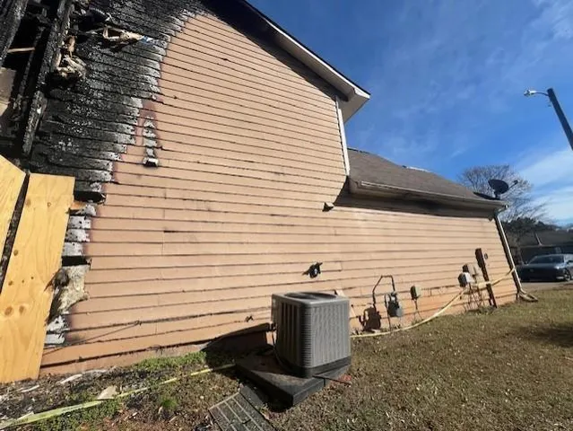 a view of a patio with table and chairs and wooden fence
