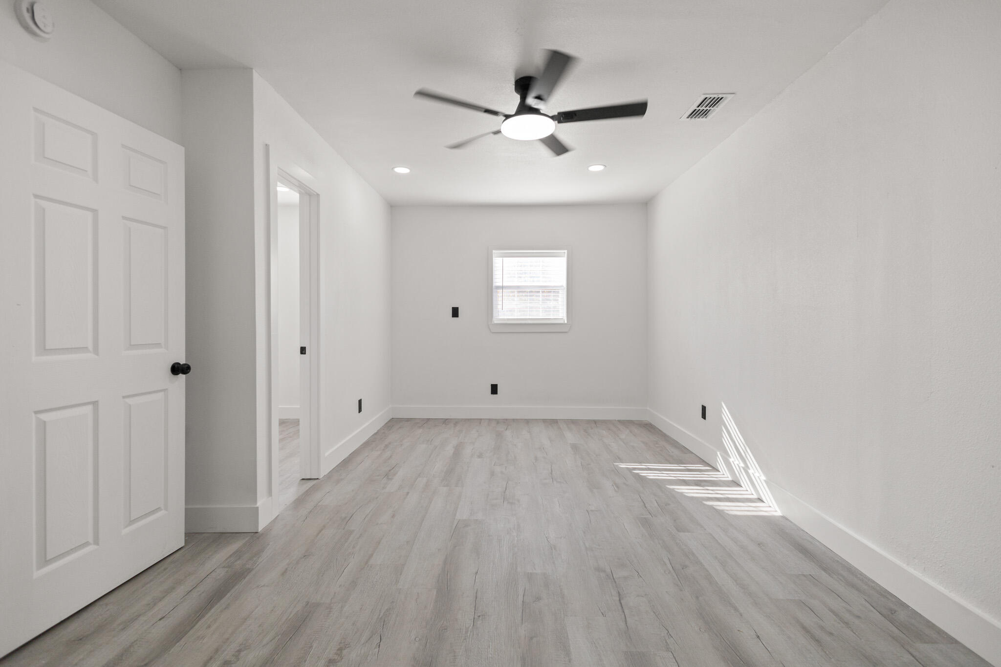 5512 45th Street Lubbock, TX 79414 - Photo 13 of 30 an empty room with wooden floor and windows
