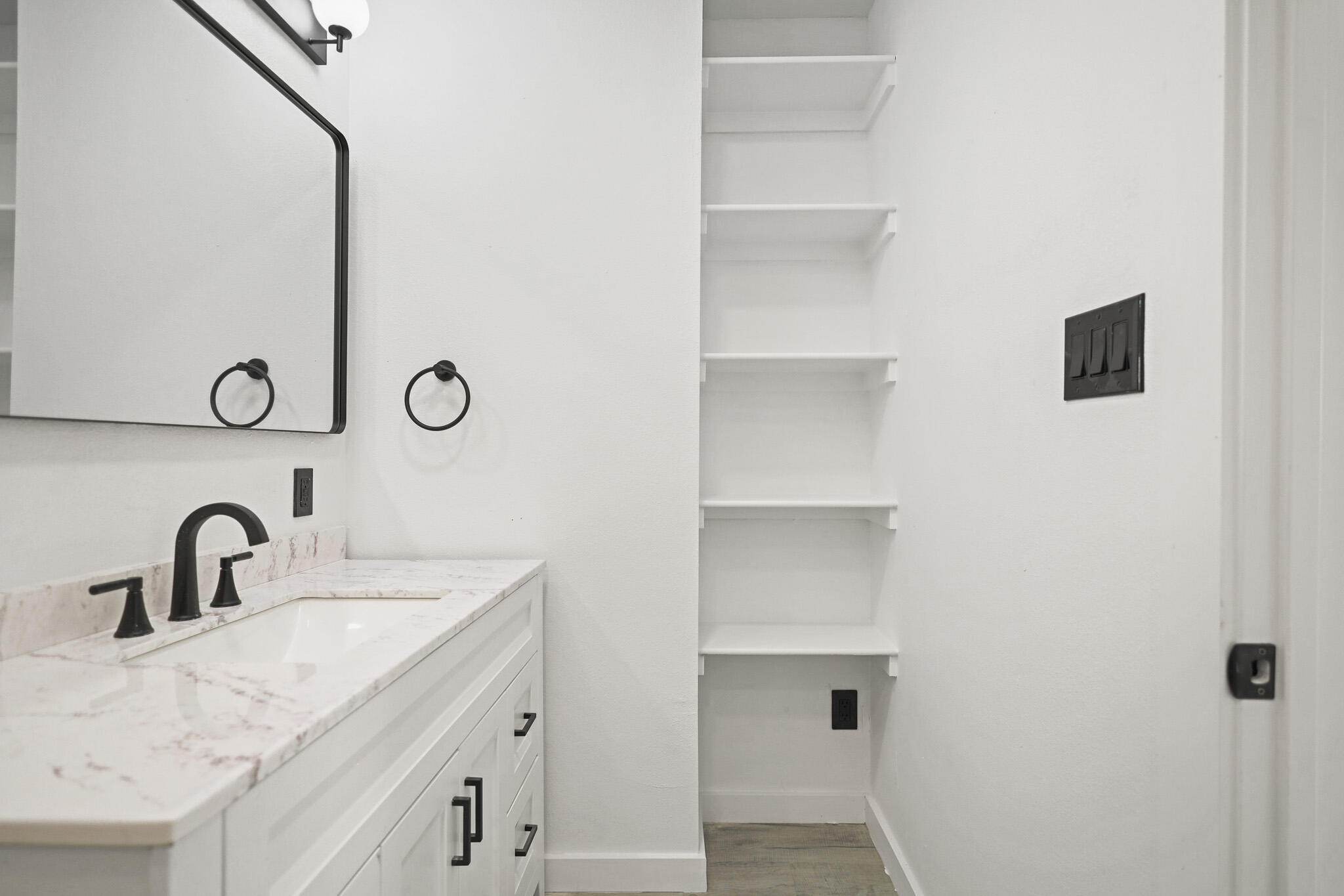 5512 45th Street Lubbock, TX 79414 - Photo 18 of 30 a bathroom with a sink and a mirror