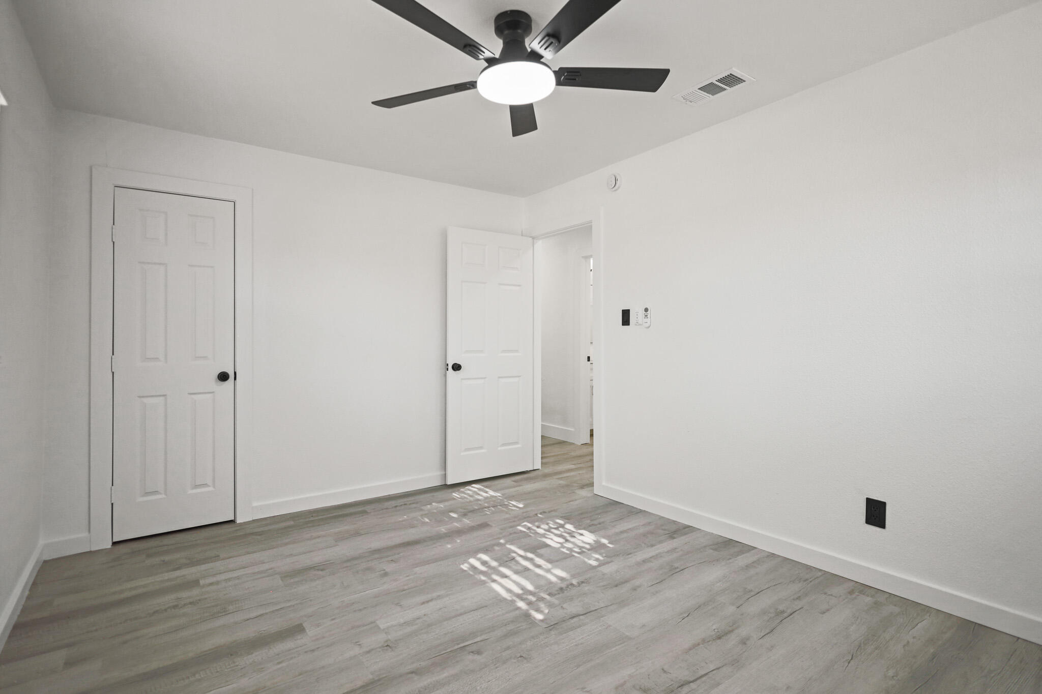 5512 45th Street Lubbock, TX 79414 - Photo 22 of 30 a view of empty room with wooden floor and fan
