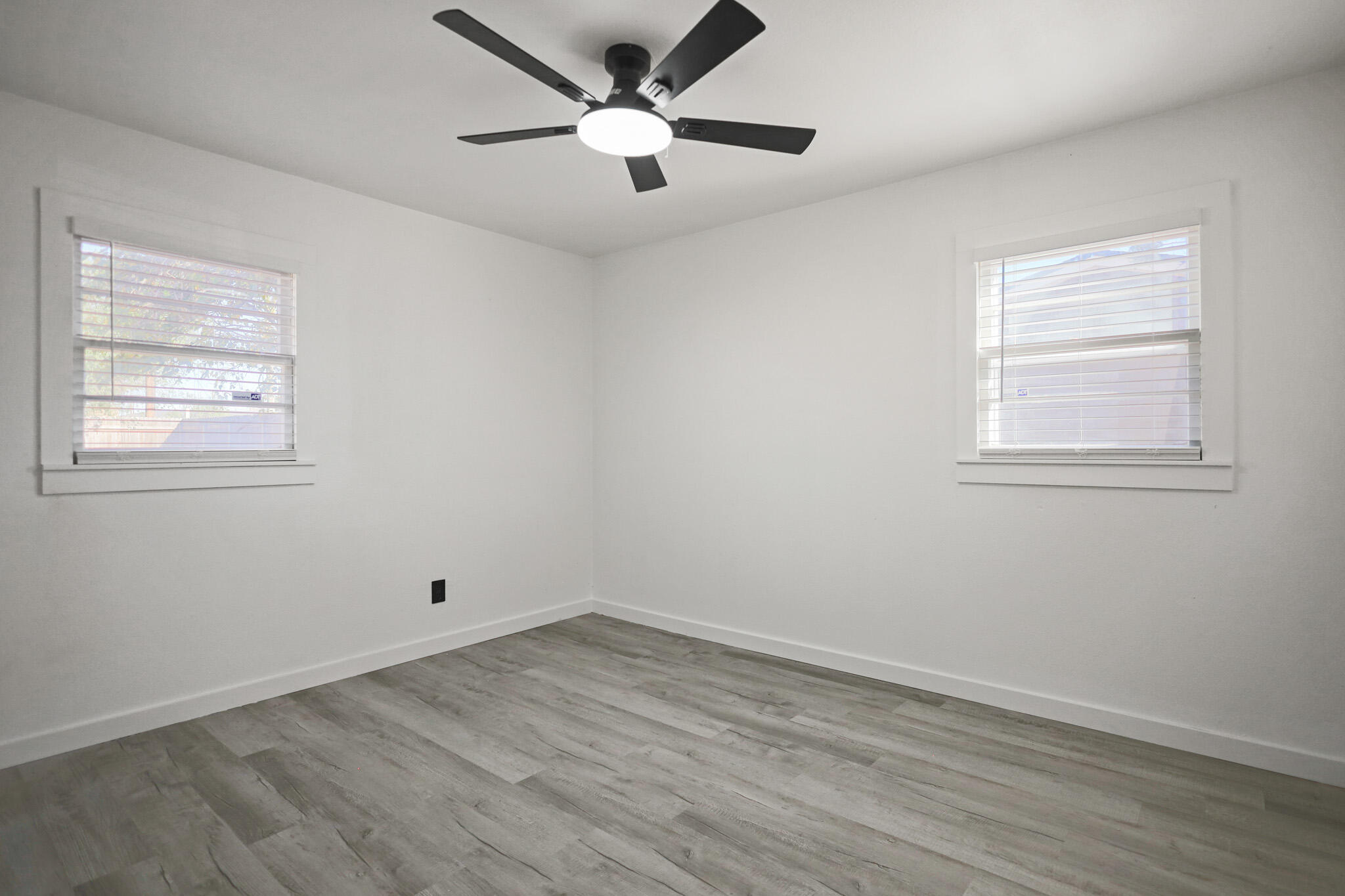5512 45th Street Lubbock, TX 79414 - Photo 23 of 30 an empty room with wooden floor and windows