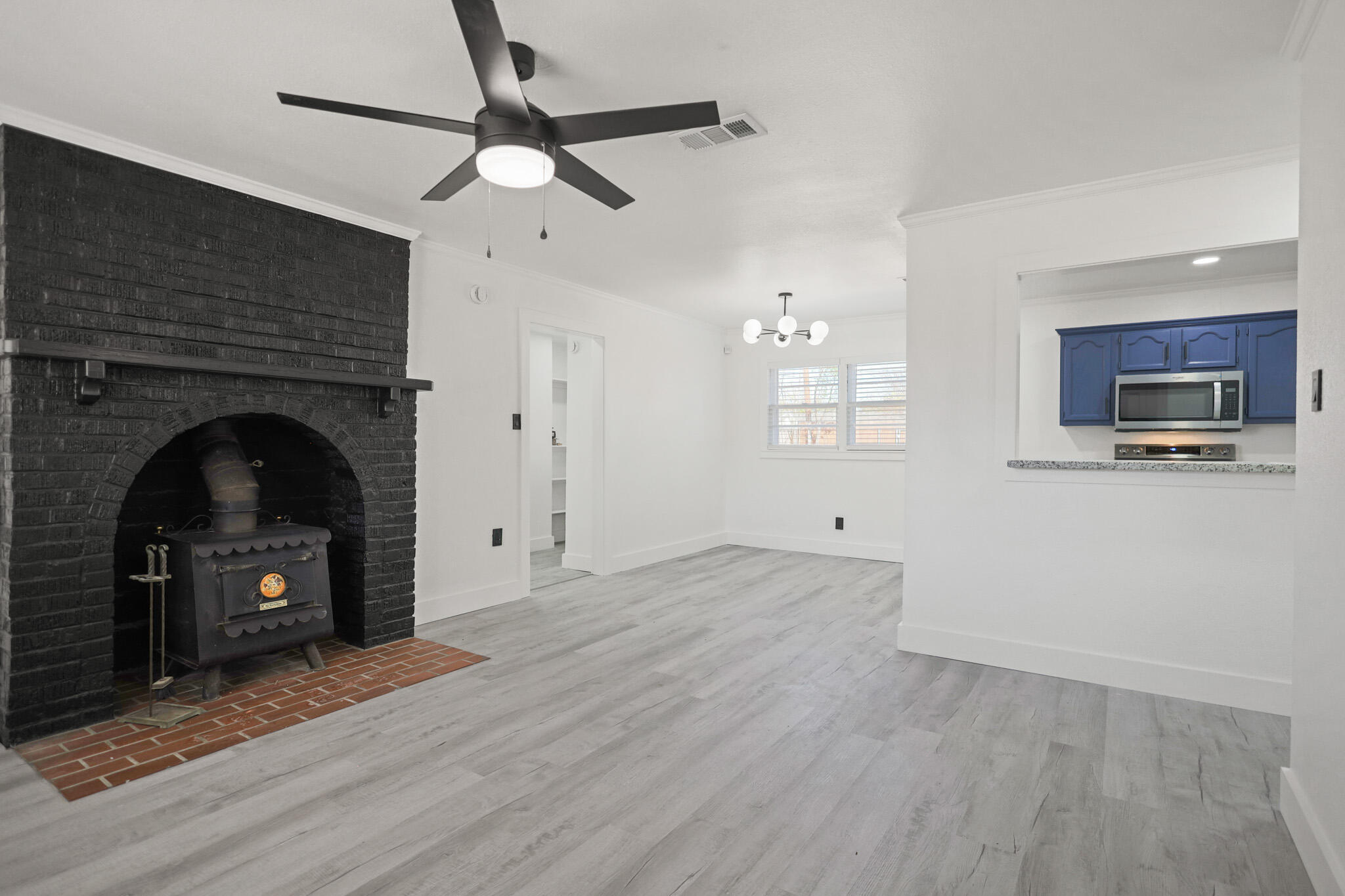 5512 45th Street Lubbock, TX 79414 - Photo 3 of 30 a view of empty room with fireplace and wooden floor