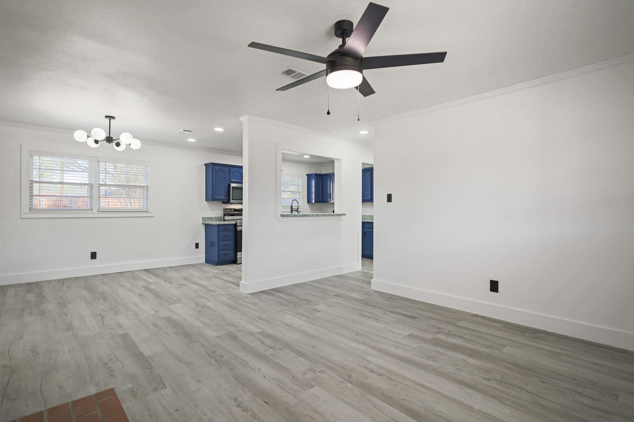 5512 45th Street Lubbock, TX 79414 - Photo 5 of 30 wooden floor in an empty room with a window