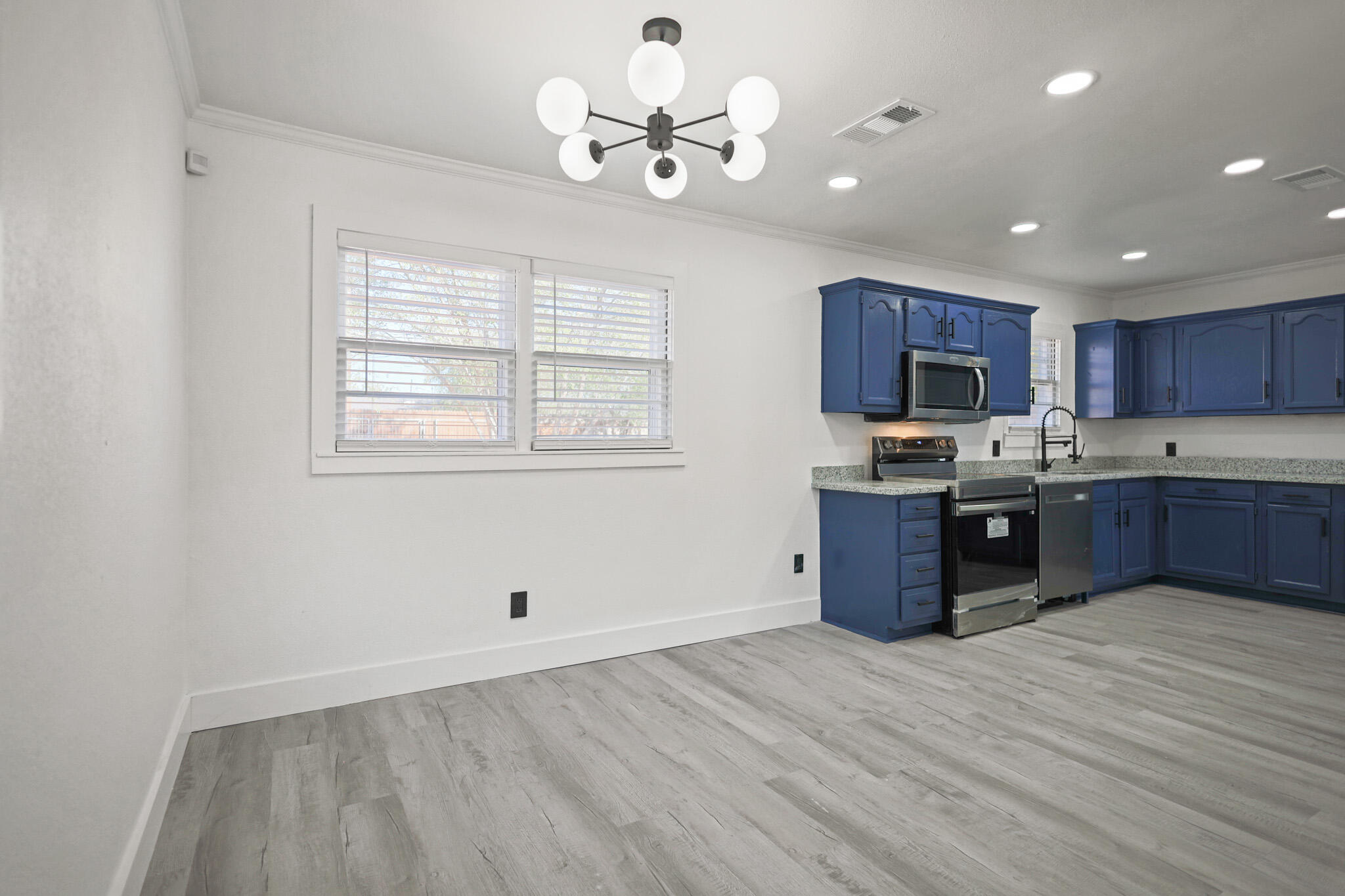 5512 45th Street Lubbock, TX 79414 - Photo 8 of 30 a kitchen with stainless steel appliances granite countertop a stove sink and cabinets
