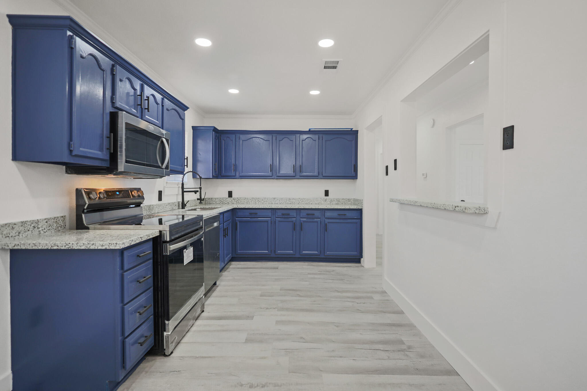 5512 45th Street Lubbock, TX 79414 - Photo 9 of 30 a large kitchen with wooden cabinets and a stainless steel appliances