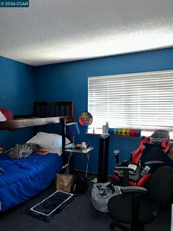 a bedroom with furniture and a window