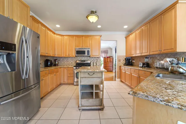 a kitchen with stainless steel appliances granite countertop a stove and a refrigerator