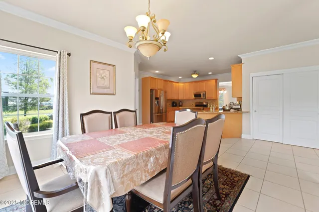 a living room with furniture a flat screen tv and a large window